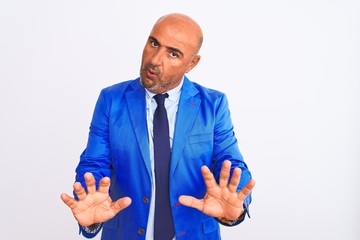 Middle age businessman wearing suit standing over isolated white background Tired hands covering face, depression and sadness, upset and irritated for problem