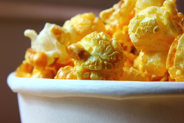 close up caramel popcorn in white paper cup