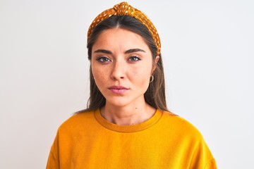 Young beautiful woman wearing yellow sweater and diadem over isolated white background with a confident expression on smart face thinking serious