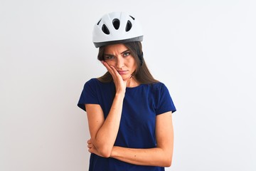 Young beautiful cyclist woman wearing security bike helmet over isolated white background thinking looking tired and bored with depression problems with crossed arms.