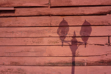 Old wood texture background with a shadow of street lamp