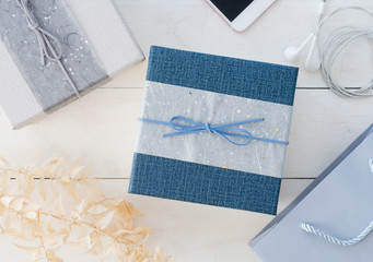 top view of gift box on white wooden background.