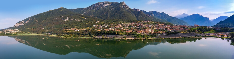 Fototapeta na wymiar Lago di Pusiano panorama view of the drone - reflections in the lake. Mountain on background