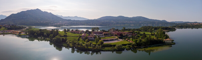 Fototapeta na wymiar Lago di Pusiano panorama view of drone - lake and mountains on background