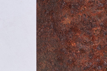 Photo of old rusty plate, corrosion, abstract pattern, rust texture near white background.