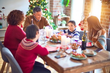 Fototapeta na wymiar Beautiful family smiling happy and confident. Eating roasted turkey celebrating christmas at home