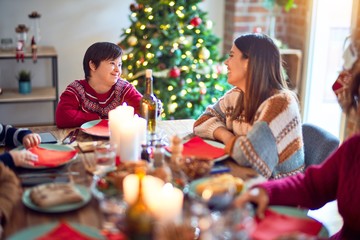 Beautiful family smiling happy and confident. Eating roasted turkey celebrating christmas at home