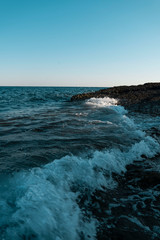 Sea waves on the wild stone beach of the sea