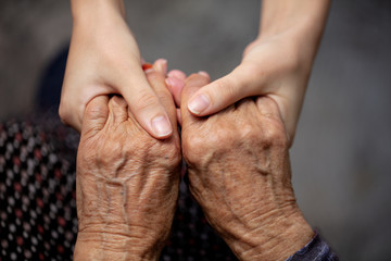 hands of old and young woman 