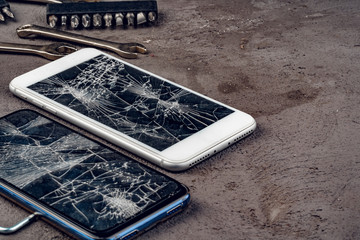 Smartphone repair concept. Damaged display of smartphone and tools