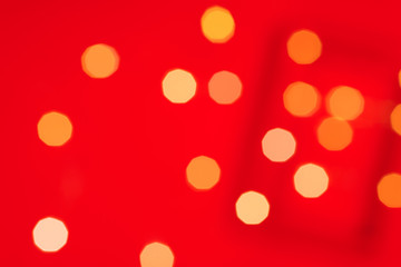 Yellow glitter boke background texture on red