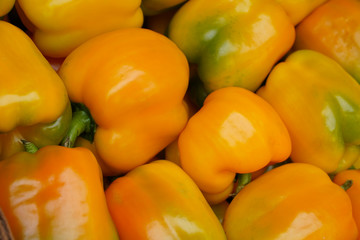 Fresh sweet yellow and green peppers at the supermarket