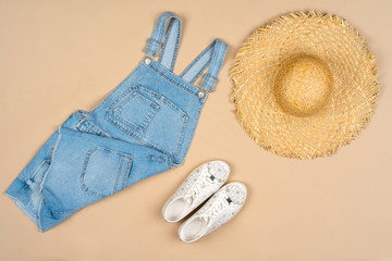 Fashion outfit for a woman on a beige background top view
