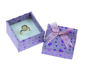 Open gift box ,Which has a heart shaped gold ring inside isolated on the white background.