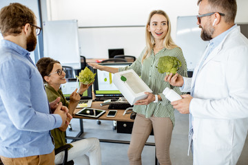Group of diverse people working on the packaging design of a new eco product in the office....