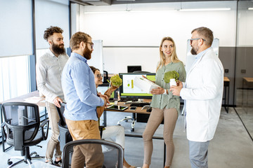 Group of diverse people working on the packaging design of a new eco product in the office....