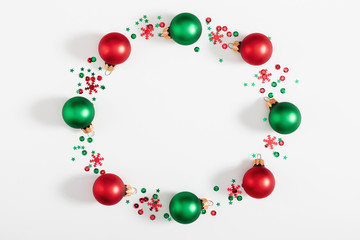 Christmas holiday composition. Wreath made of red and green balls  on white background. Christmas, New Year, winter concept. Flat lay, top view, copy space