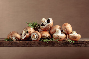 Fresh brown mushrooms champignon on a old wooden table.