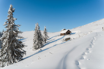 Fototapeta na wymiar Beautiful pictures of nature in winter. Landscape with mountain huts in the snow.