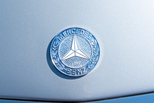 Mercedes car logo on white surface of a vintage car