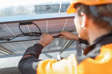 Electrician connecting solar panels