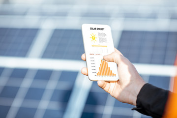 Examining production of solar power plant with digital tablet