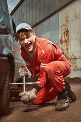 Cute man in red overall tunning his lovely retro car