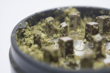 macro shot of an herb grinder with marijuana in it