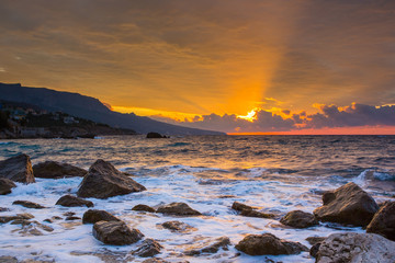 Morning seascape with sunrise and coastal stones