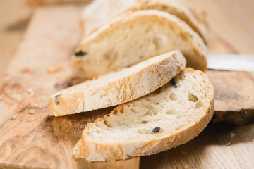 closeup slices of ciabatta on wood board