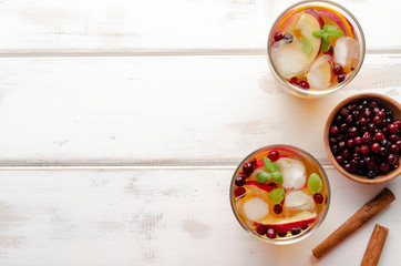 Spiced apple mocktail with mint and cinnamon. wooedn background