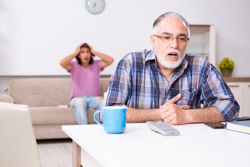Young student and his old grandpa at home