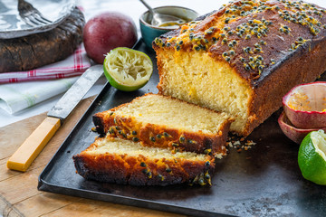 Lime and passion fruit drizzle cake on wooden board