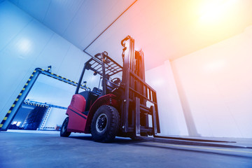 Forklift in a large industrial freezer warehouse. Empty warehouse for vegetable storage. © romaset