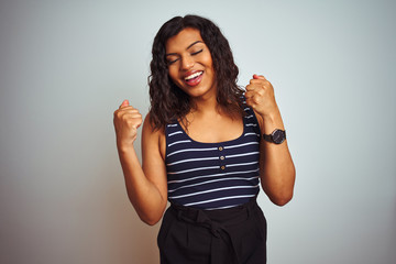 Transsexual transgender woman wearing striped t-shirt over isolated white background excited for success with arms raised and eyes closed celebrating victory smiling. Winner concept.