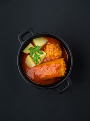 Green pepper stuffed with pork and rice in tomato sauce. Traditional Slovak food. Minimal concept.