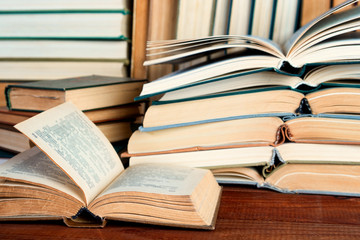 Open book on wood desk in the library room  for education background and back to school concept.