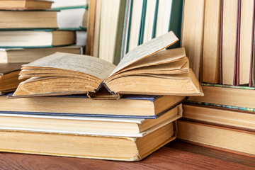 Open book on wood desk in the library room  for education background and back to school concept.