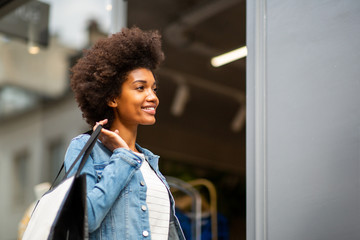 african american woman window shopping for clothes by store