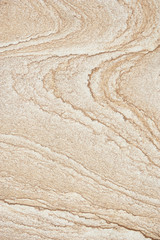Close-up of the natural pattern of a weathered sandstone wall in a full frame background