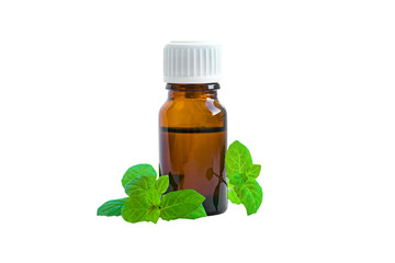 Mint oil in a brown glass vial with a white lid with green leaves of the medicinal plant mint,...