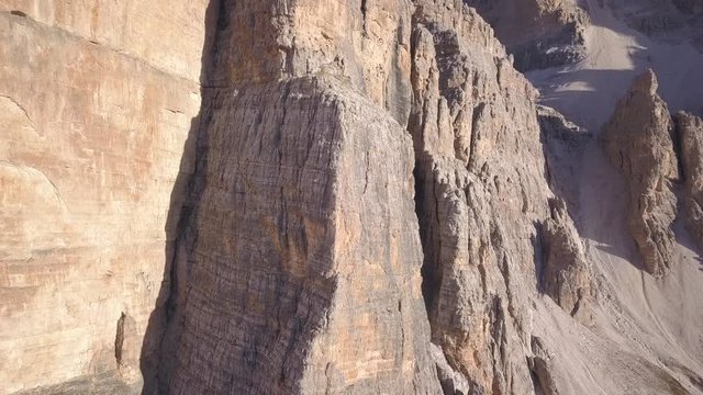 Front drone aerial footage at the morning light to the special and famous Tofana wall rocks in Dolomites, near Cortina D'Ampezzo.
