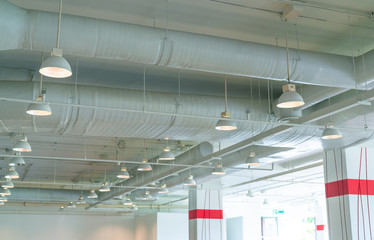 Air duct, air conditioner pipe, wiring pipe, and fire sprinkler system. Air flow and ventilation system. Building interior. Ceiling lamp light with opened light. Interior architecture concept.