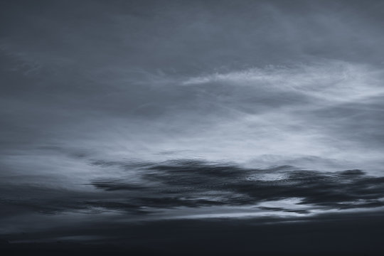 Dark dramatic sky and clouds. Background for death and sad concept. Gray sky and fluffy white clouds. Thunder and storm sky. Sad and moody sky. Nature background. Dead abstract background. Cloudscape. © Artinun