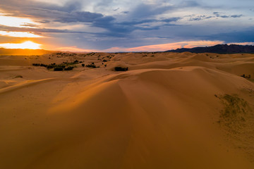 Fototapeta na wymiar Sunset over the sand dunes in the desert