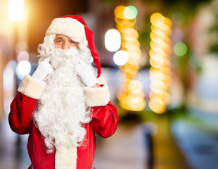 Middle age handsome man wearing Santa Claus costume and beard standing Smiling with open mouth, fingers pointing and forcing cheerful smile