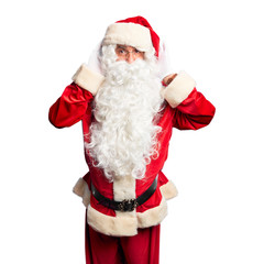 Middle age handsome man wearing Santa Claus costume and beard standing Trying to hear both hands on ear gesture, curious for gossip. Hearing problem, deaf