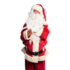 Middle age handsome man wearing Santa Claus costume and beard standing Pointing to both sides with fingers, different direction disagree