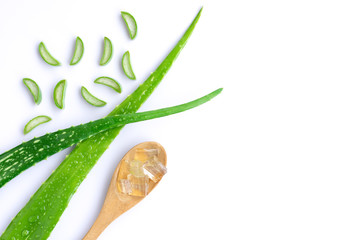 Green fresh aloe vera leaf with sliced and aloevera gel in wooden spoon isolated on white background.Natural herbal medical plant ,skincare ,healthcare and beauty spa concept. Top view. Flat lay.