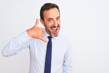 Middle age businessman wearing elegant tie standing over isolated white background smiling doing phone gesture with hand and fingers like talking on the telephone. Communicating concepts.